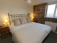 Bedroom with exposed wall